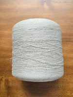 Load image into Gallery viewer, Ishikawa Safari Washi Blend Cone Yarn showcasing a soft white color in a cone shape on a wooden surface.