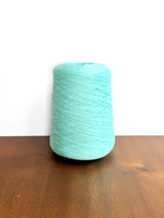 Load image into Gallery viewer, 100 Cotton Tape Cone Yarn in a soft mint green color, showcasing its smooth texture and cone shape.