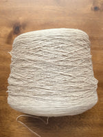 Load image into Gallery viewer, 100 Linen Cone Yarn displayed on a wooden surface, showcasing its natural texture and lightweight design.