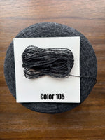 Load image into Gallery viewer, UPW 100 Extrafine Merino Wool cone yarn in Color 105, showcasing a dark gray shade ideal for outerwear crafting.