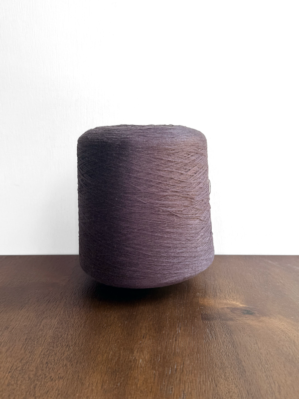 100 Linen Cone Yarn - Deep espresso color cone yarn on wooden surface.
