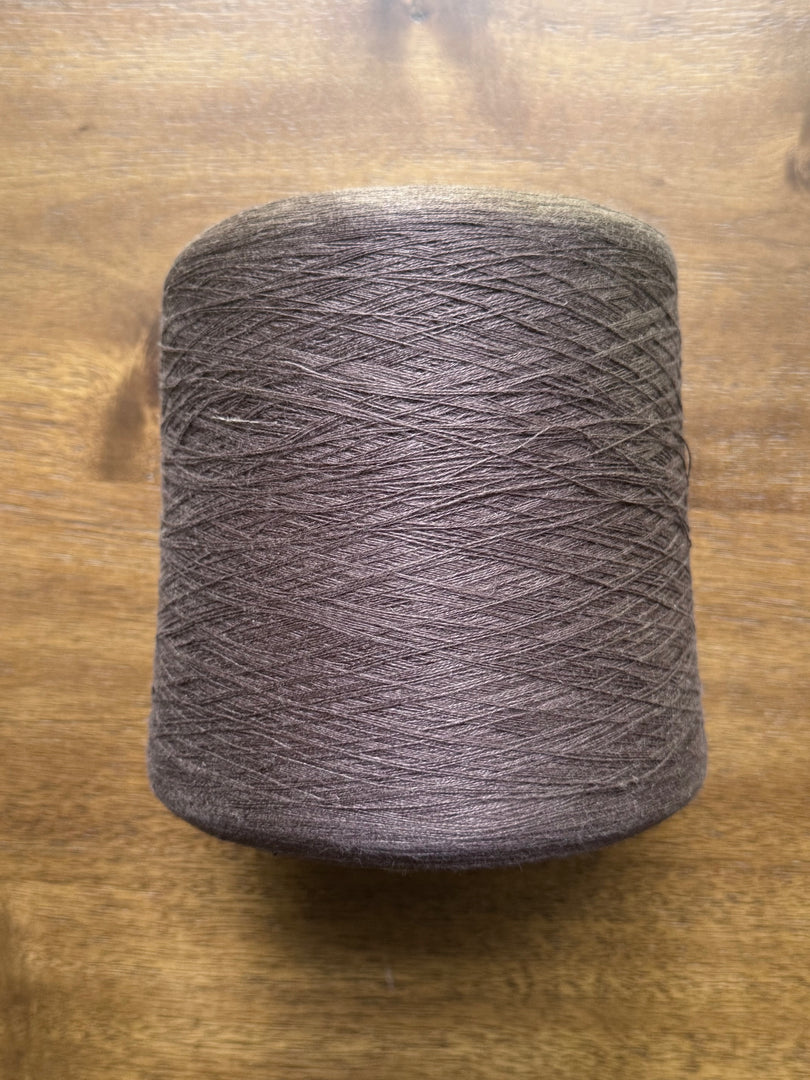 100 Linen Cone Yarn - Deep espresso color cone yarn on wooden surface.