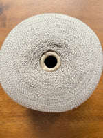 Load image into Gallery viewer, Ishikawa Safari Washi Blend Cone Yarn showcasing a soft white color in a cone shape on a wooden surface.