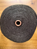 Load image into Gallery viewer, Maruyasu Techne 51 Paper 49 Modal Cone Yarn on a wooden table, showcasing its light color and smooth texture.